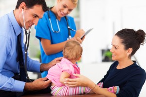 doctor examining a baby girl
