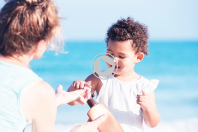 mom putting sunscreen on daughter's face