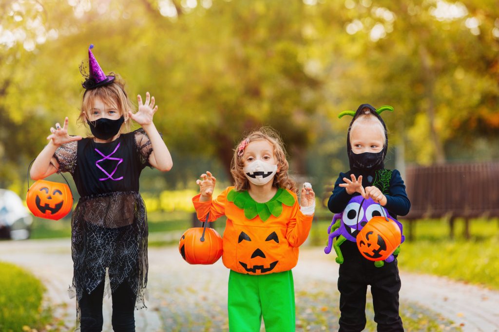 Kids in masks trick or treating for Halloween