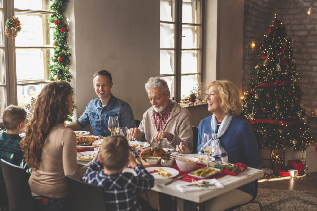 Family gathered for Christmas dinner practicing holiday safety tips