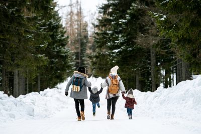 Family walking with children, maintaining a routine on winter break
