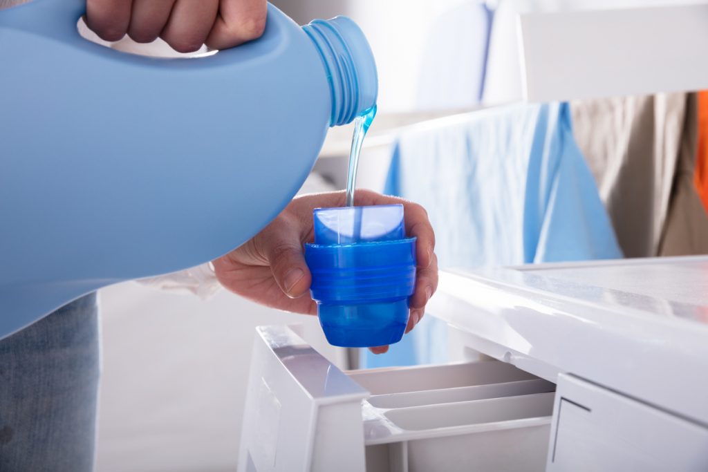 Person pouring baby detergent, popular products to forgo
