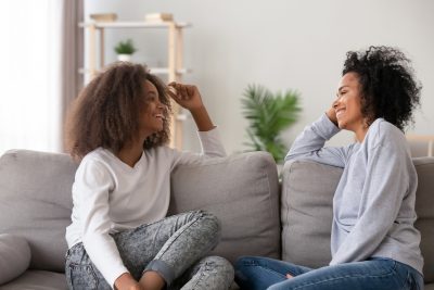 Mother and daughter have effective communication on a couch